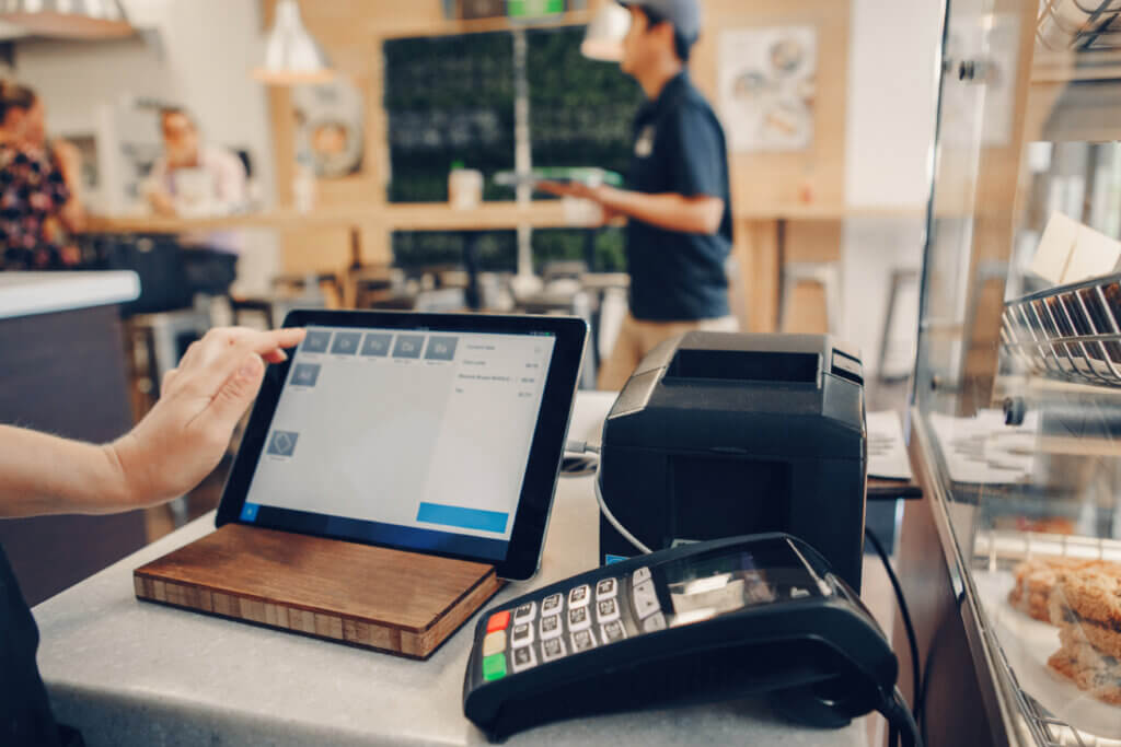 Small business owner using a tablet at the counter on Bluespan business internet