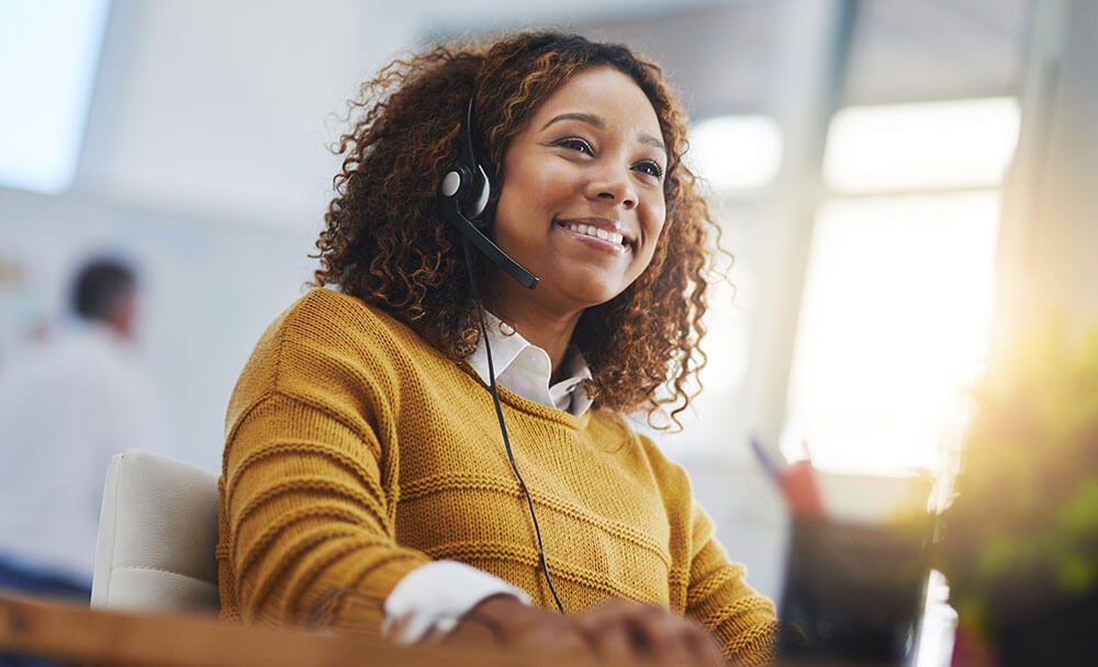 Customer service representative using a headset for business phone and VoIP communication
