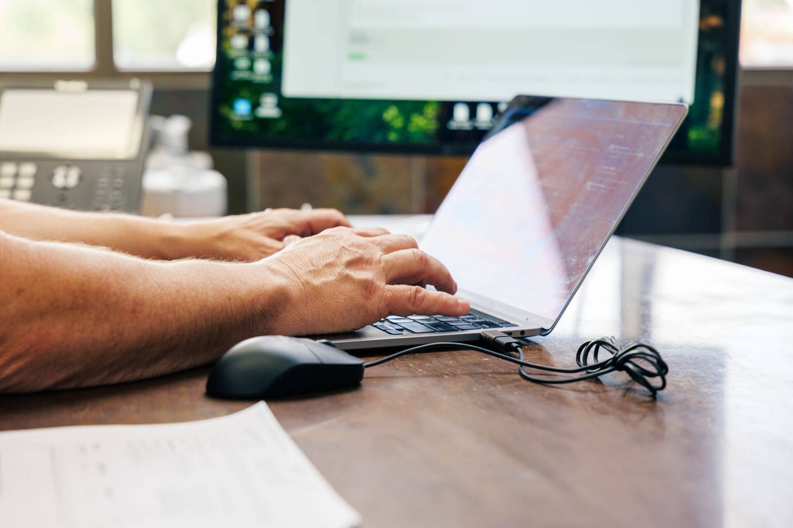 Person using laptop to check high speed internet Arizona coverage map