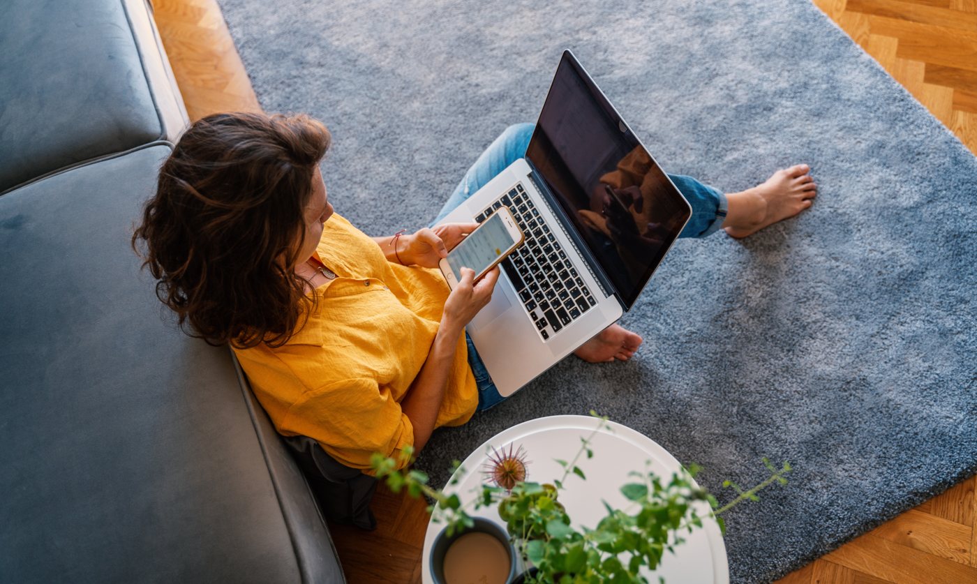 Woman using a laptop at home on Bluespan Fiberwave fixed wireless internet