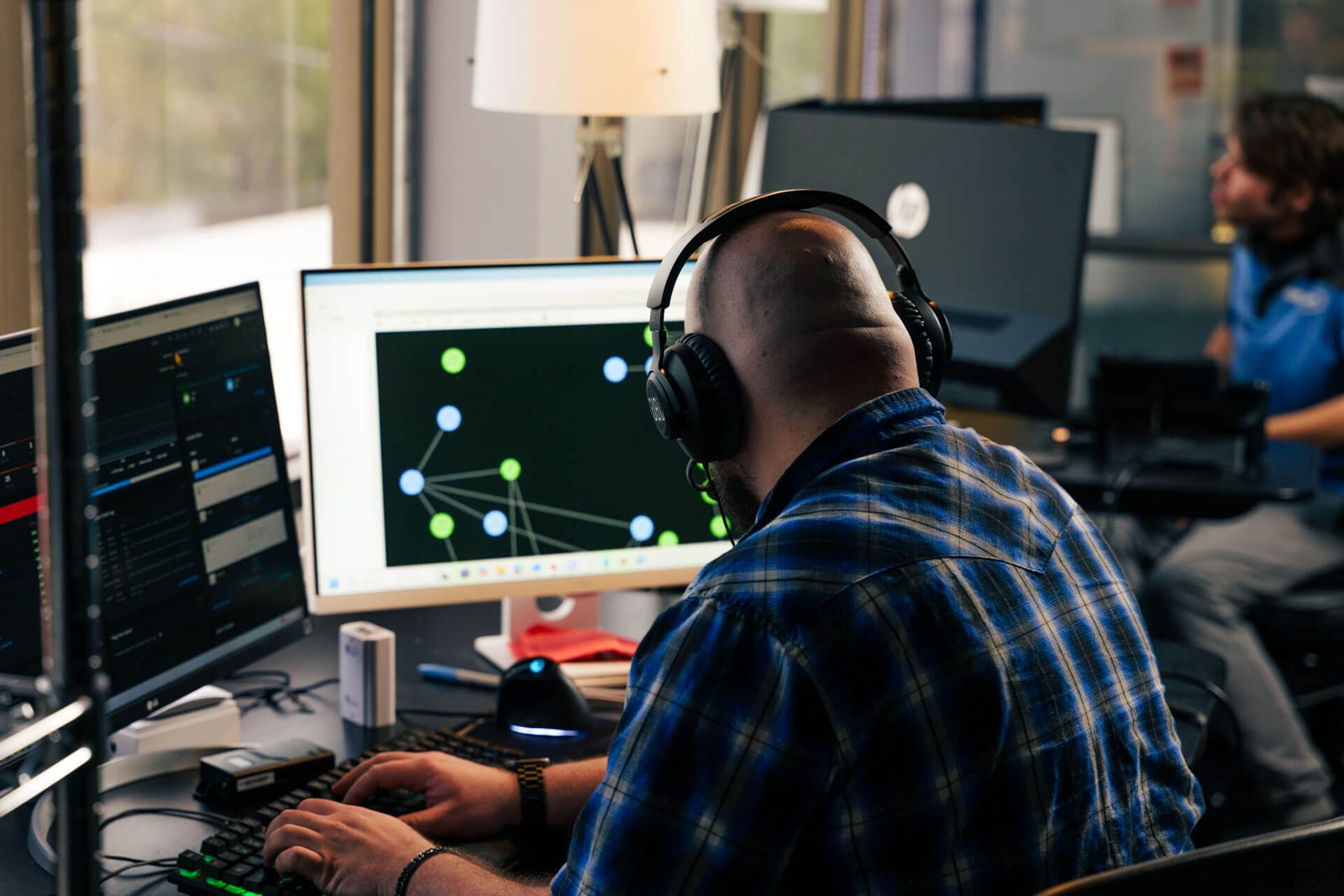 Office professional using headset and computer with network management services support