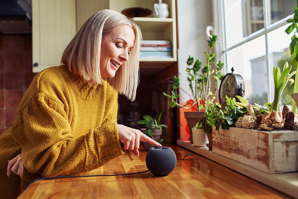 Woman using voice assistant with smart home connectivity powered by home internet