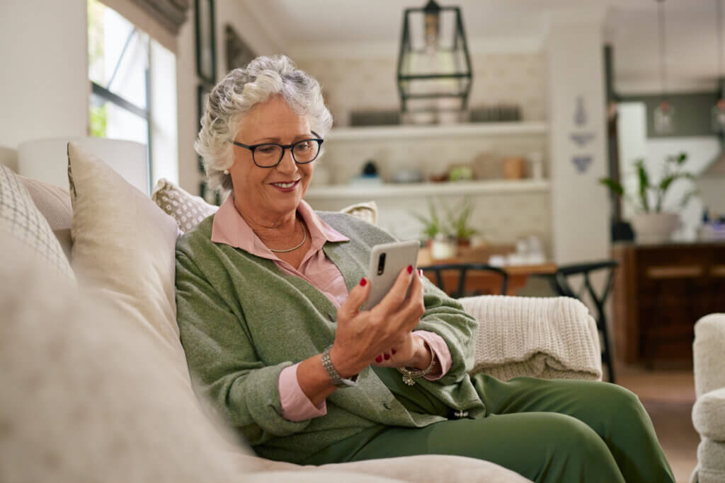 Woman on couch using home phone services for clear and reliable communication
